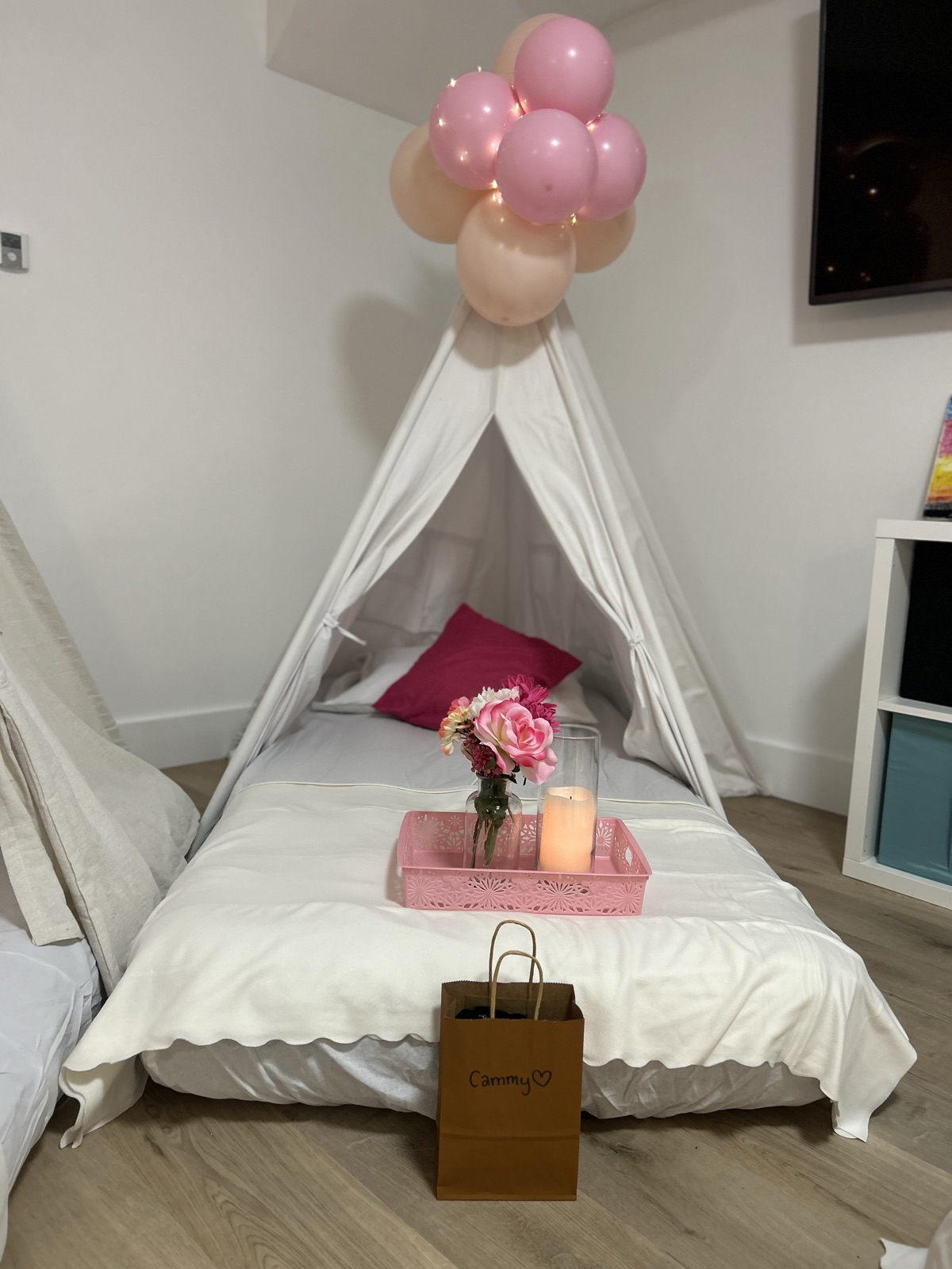 A sleepover tent made up with balloons and a gift, styled by PrettyFly
